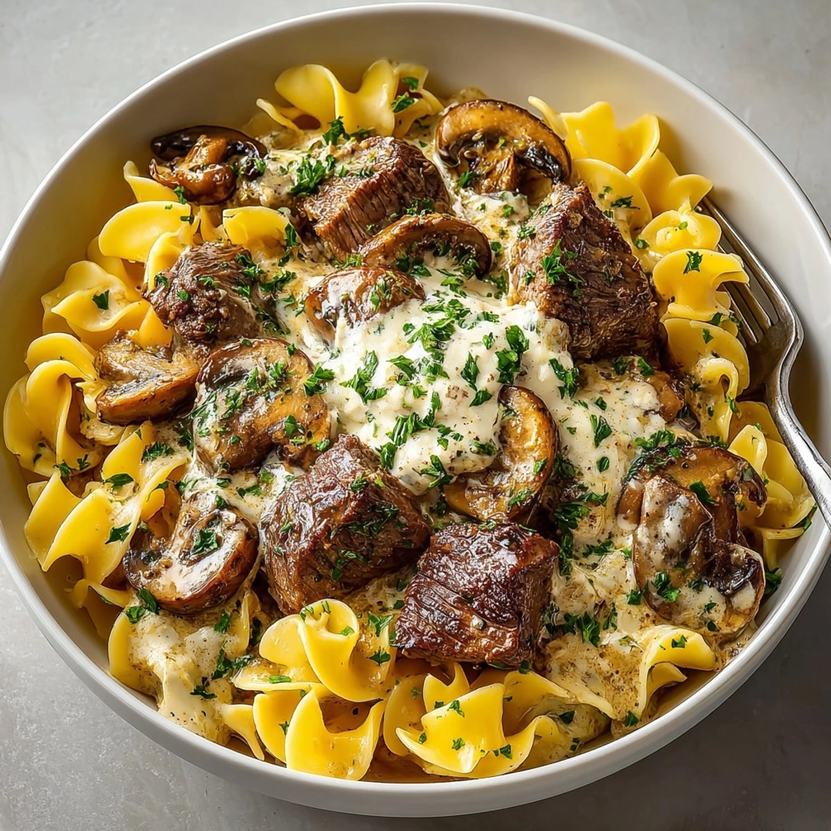 Creamy slow cooker beef stroganoff simmers, ready for egg noodles, rich and savory.