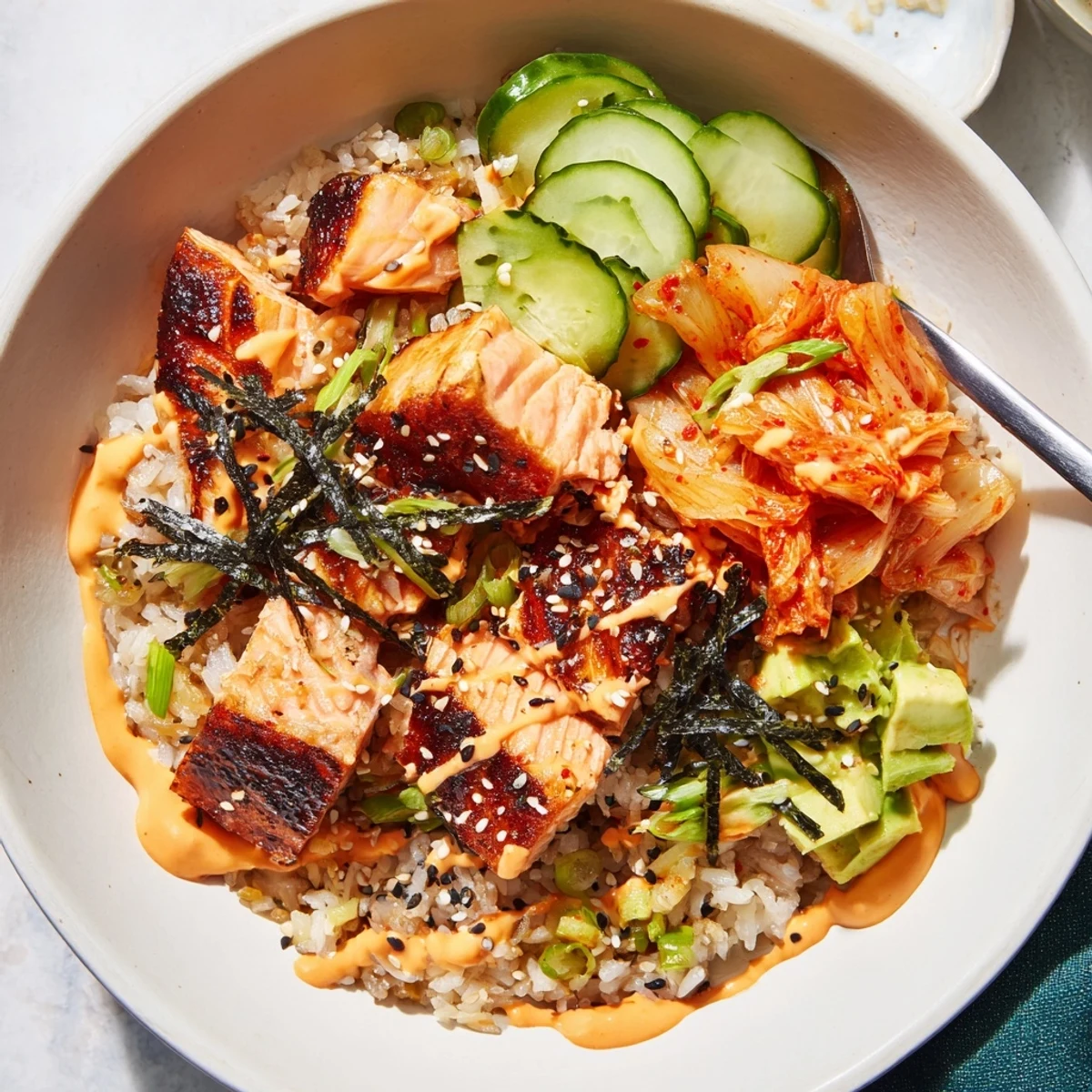 Golden crispy rice beneath succulent salmon, creating a mouthwatering rice bowl.  