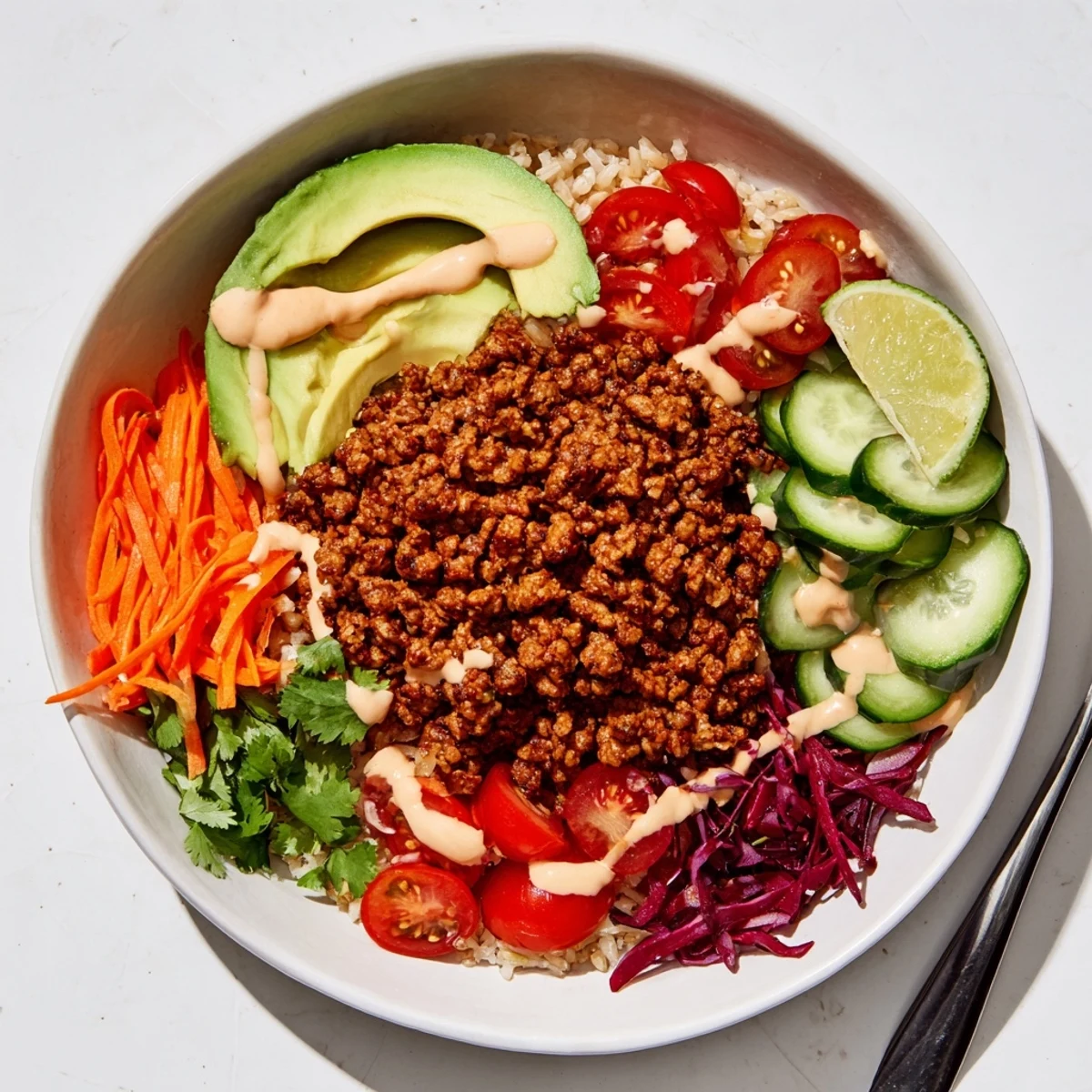 Savory plant-based meat bowl served on a bed of quinoa, garnished with cilantro.  