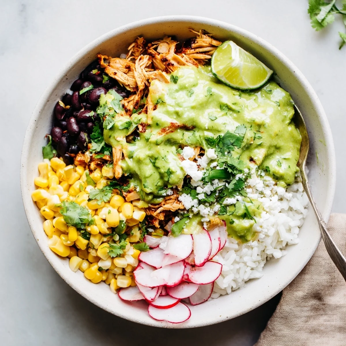 Zesty Green Enchiladas Rice Bowl featuring tender chicken and vibrant toppings in a cozy dish.  