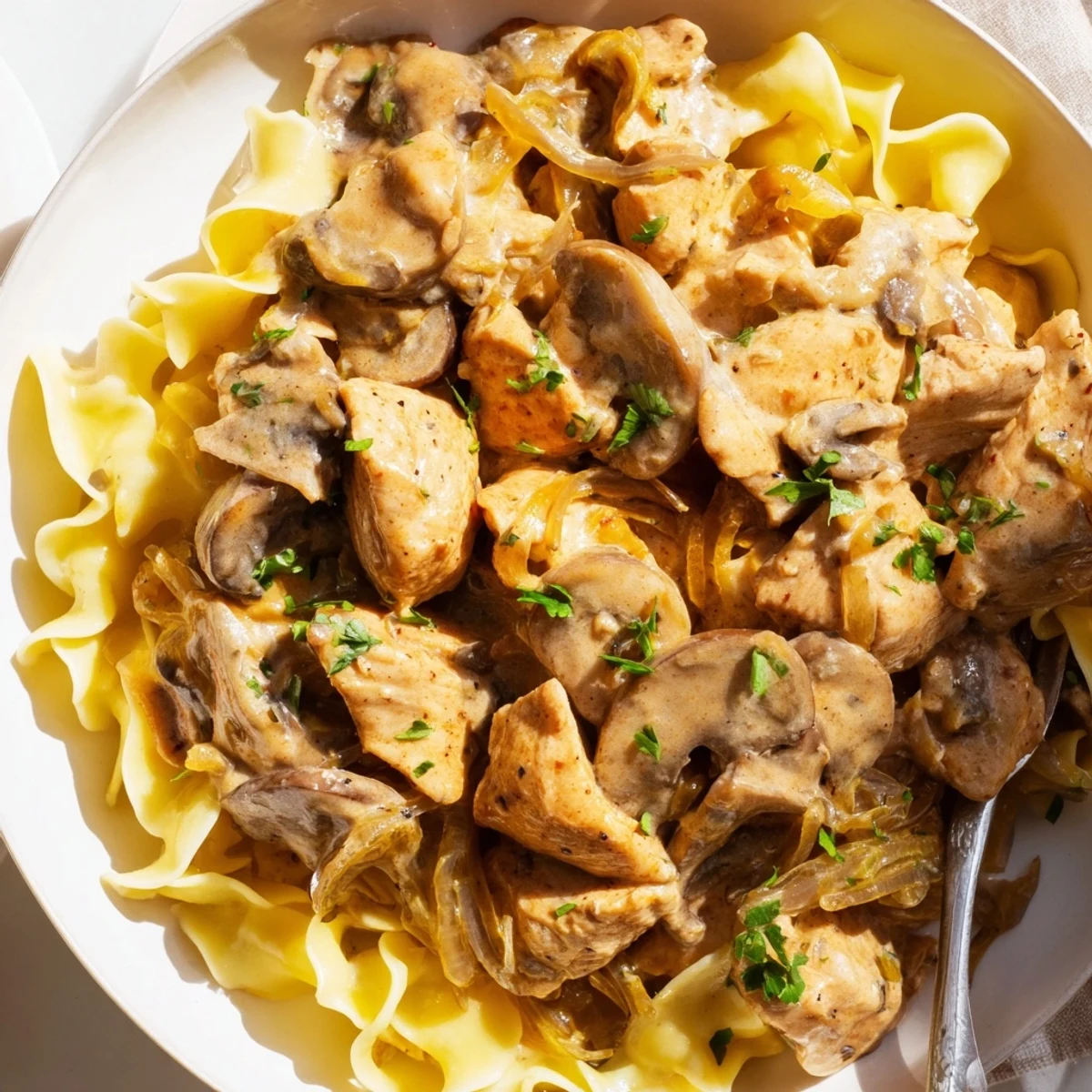 A comforting bowl of Creamy Chicken Stroganoff with creamy sauce and aromatic herbs.