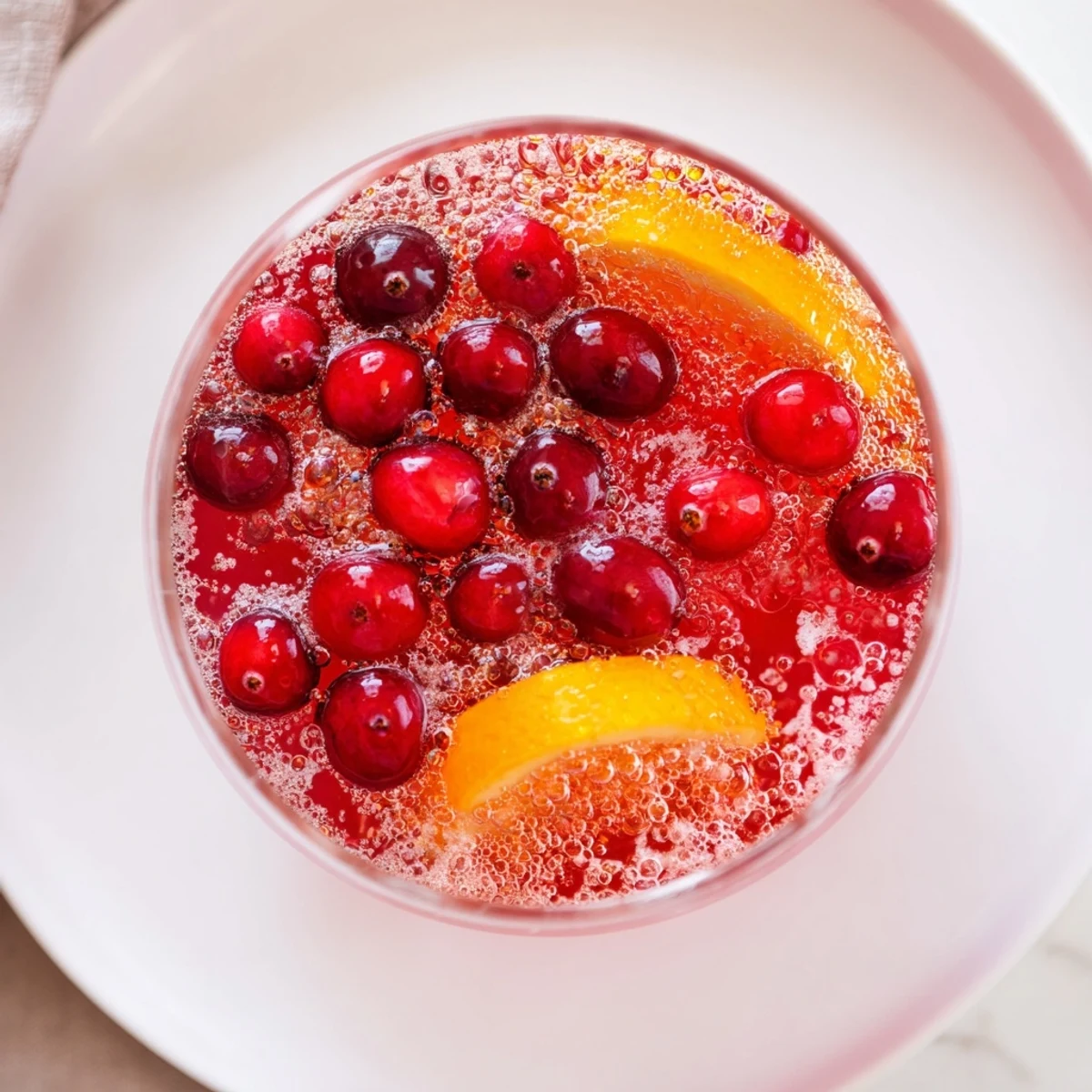 Pouring cold ginger ale into vibrant 3-Ingredient Holiday Punch for a fizzy, delicious finish.