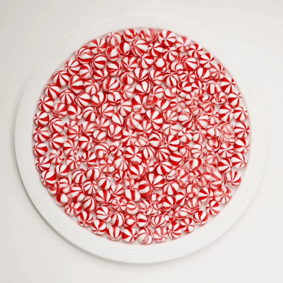 Hot, melted peppermint candies are draped over a bowl, sculpting a beautiful, easy no-bake candy bowl.