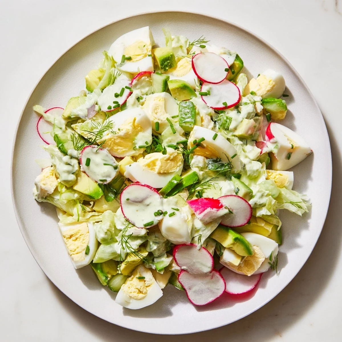 Vibrant Green Goddess Chopped Egg Salad with creamy dressing and fresh, crisp vegetables, ready to enjoy.