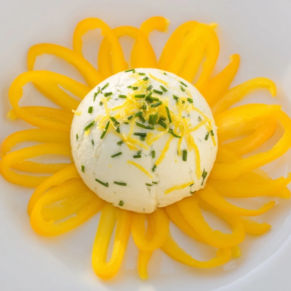 Vibrant Tuscan Sunburst appetizer: yellow bell pepper sun rays with creamy lemon goat cheese center, ready to serve.