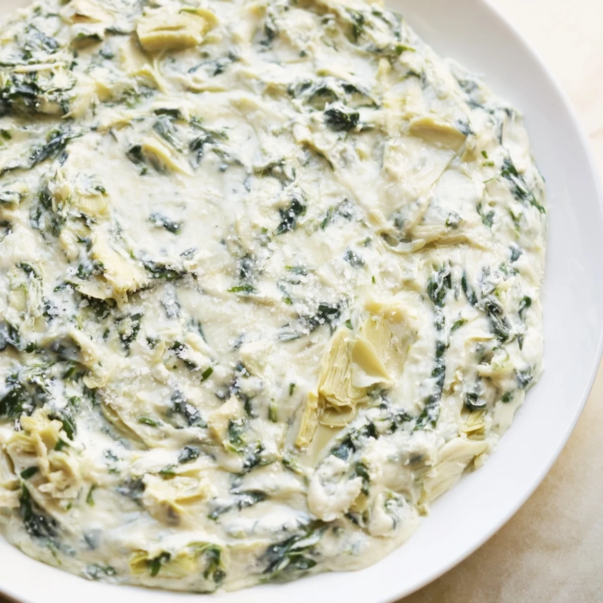 Savory spinach artichoke dip, brimming with melted cheese and artichoke pieces, enticing flavor.