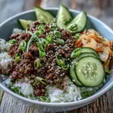 Korean Ground Beef Bowl with savory glazed beef, crisp carrots and cucumber over rice.