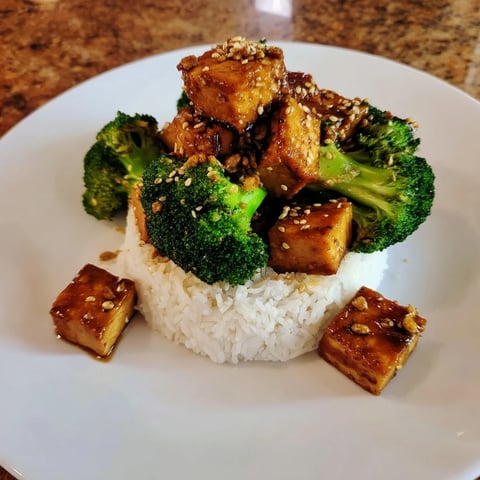Golden, crispy sesame tofu and broccoli, richly coated and paired beautifully with fluffy white rice.