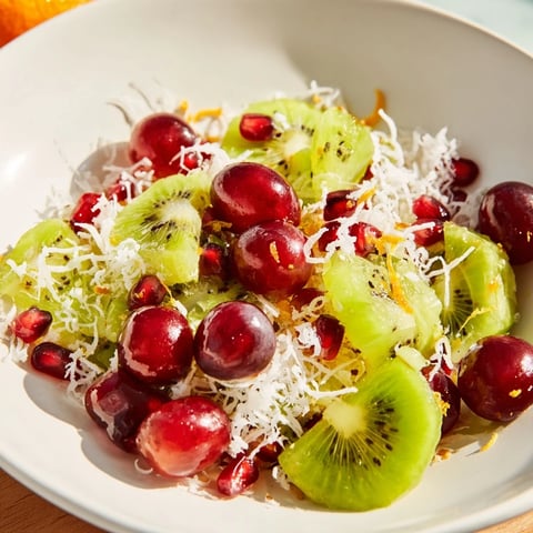 Vibrant Snowflake Fruit Medley, with glistening pomegranate and kiwi, ready to enjoy as a refreshing dessert.
