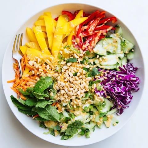A creamy Thai Peanut Mango Veggie Salad, showing layers of textures and colors.