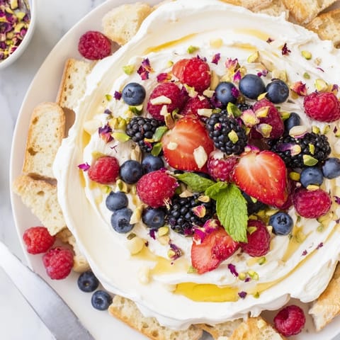Whipped cream cheese and vibrant berries create a delightful Butter Board Dessert.  