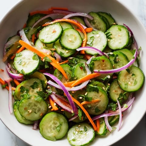 Cooling cucumber salad remix topped with sesame seeds for added flavor and crunch.  