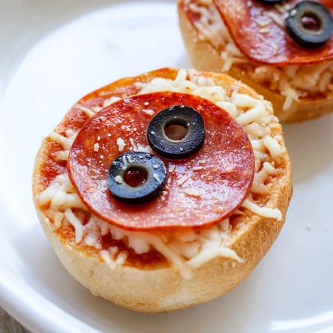 Close-up of Santa Belt Mini Pizza Bites, with melted mozzarella and perfectly crisp pepperoni belts.