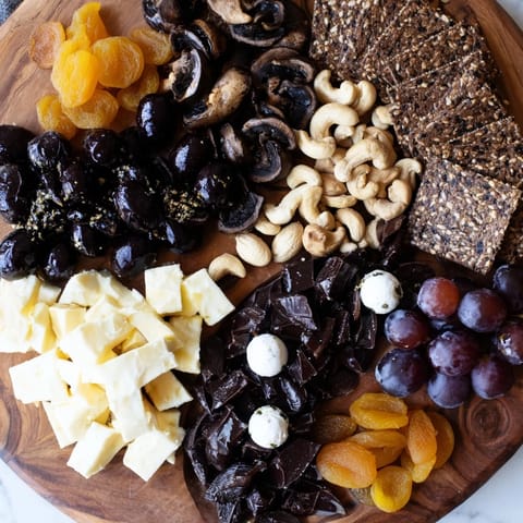 This Yin and Yang Balance Board recipe image shows a balanced arrangement of dark and light snacks for serving.