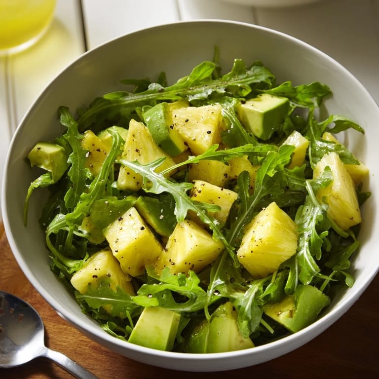 Vibrant Pineapple Avocado Summer Salad with creamy avocado and peppery arugula delight.  