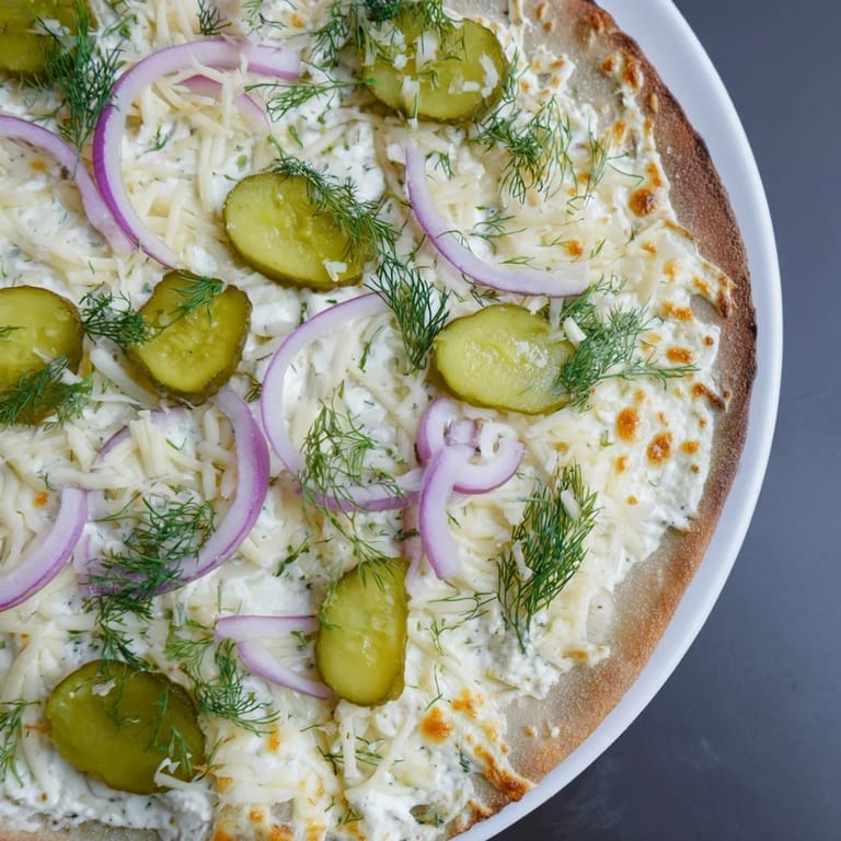 Deliciously unique pickle pizza, featuring melted mozzarella and zesty crème fraîche sauce.