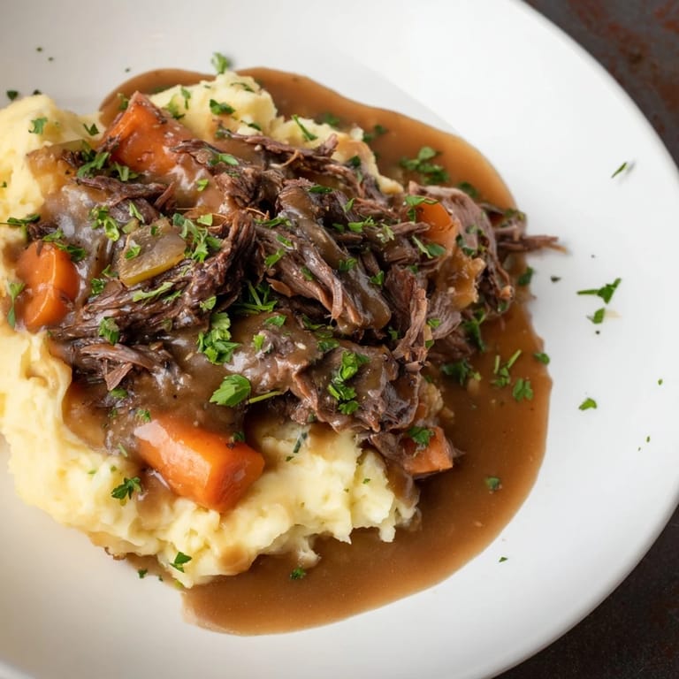 Hearty slow cooker pot roast on a plate, rich gravy pooling around vegetables and potatoes.