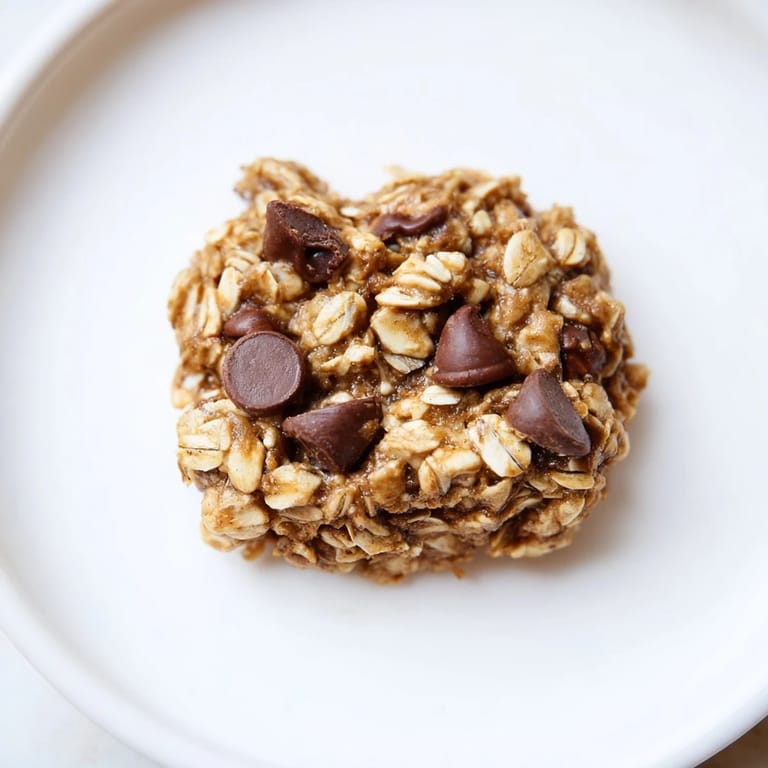 Chewy Oat-Banana Chocolate Chip Cookies scattered on a cooling rack, perfect for a sweet treat.