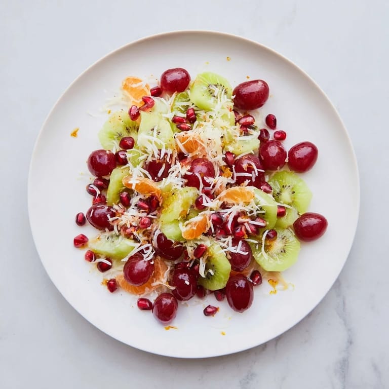 A beautifully arranged Snowflake Fruit Medley, drizzled with honey dressing and topped with fluffy coconut flakes.