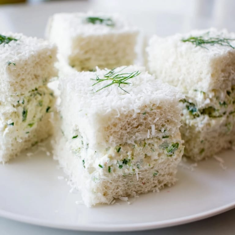 Perfectly round Snowball Tea Sandwich Bites, ready to serve on a platter for your next tea party.