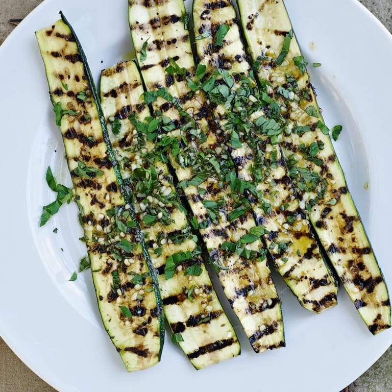 Tender, grilled Garlic Herb Zucchini arranged on a platter, ready to serve for a summer barbecue.
