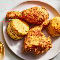 Golden-brown, crispy Southern Fried Chicken alongside warm, fluffy buttermilk biscuits ready to be enjoyed.